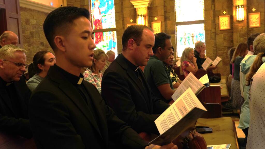 priests praying in a catholic church